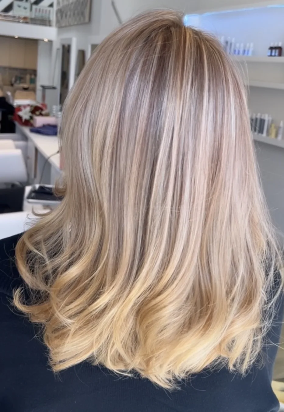 Creamy blonde highlights blown out with a soft bend at the ends