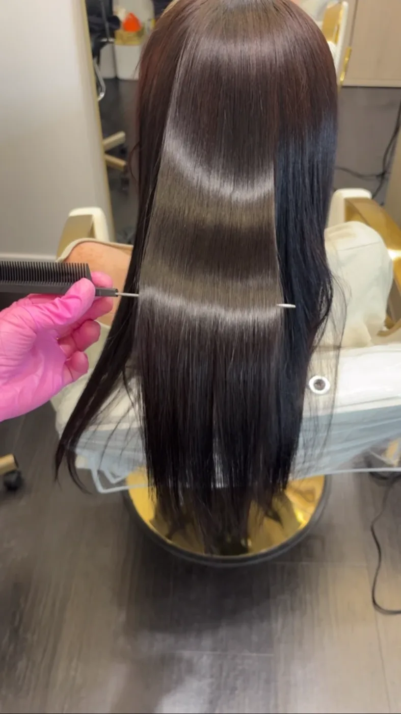 Deep espresso hair sectioned smooth with a high-shine mirror finish
