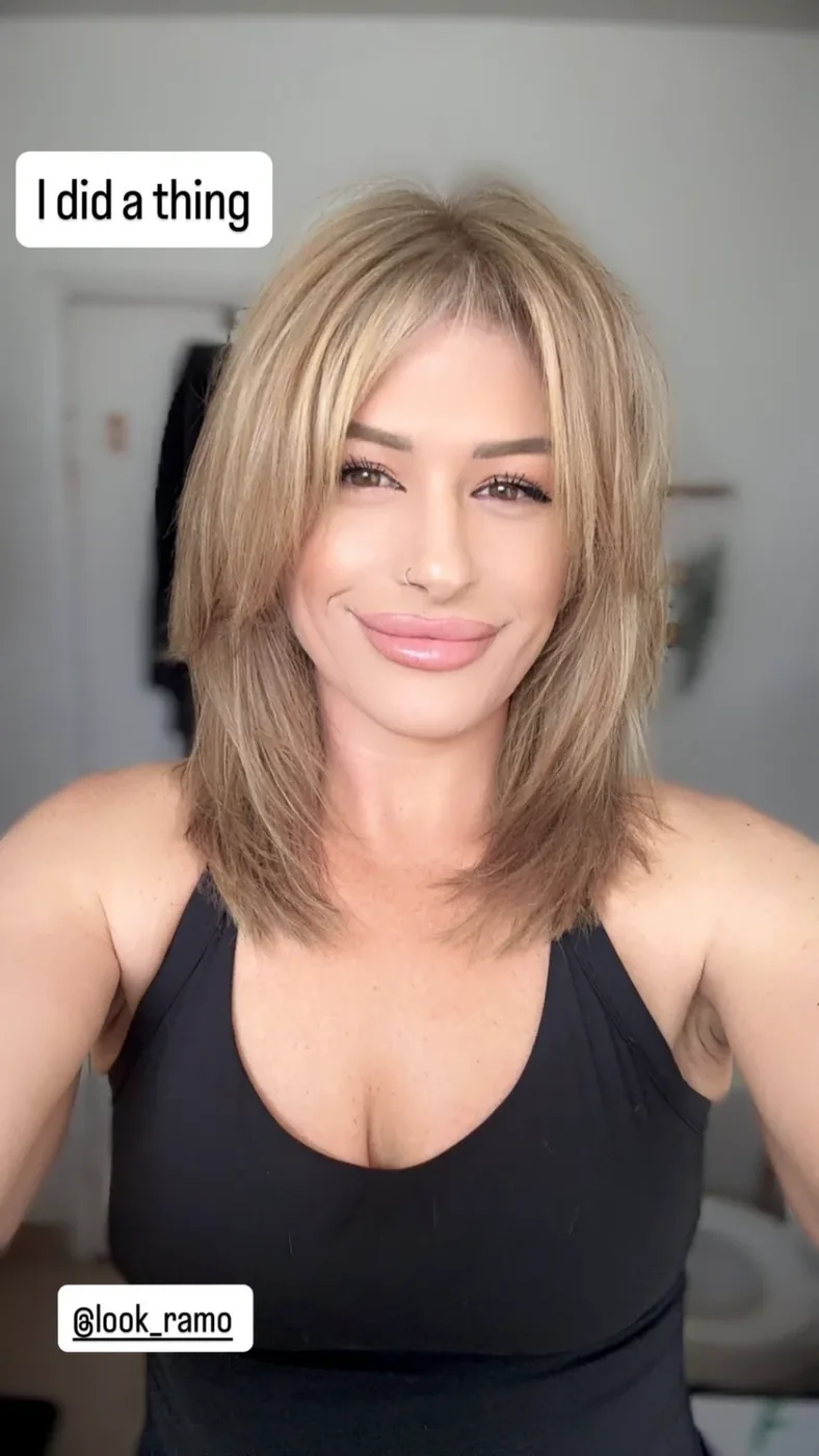Blonde shag cut with face-framing layers and a soft fringe